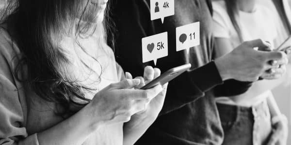 Happy friends using smartphones social media concept social media